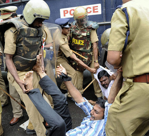 Police arrest DYFI workers who were protesting against Kerala CM Oommen Chandy over the Solar Scam in Kozhikode on Saturday. PTI Photo