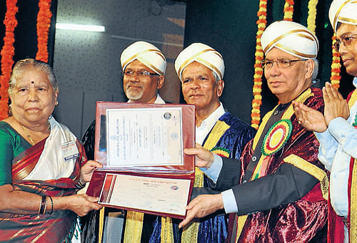 age no bar: T P Shantha Bai receives her fourth degree, from Governor H R Bhardwaj in Mysore on Tuesday. DH Photo