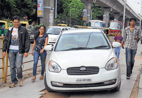 callous attitude Pedestrians have to fight for space on MG Road as cars are being parked on the footpath.  DH Photos by Dinesh S K