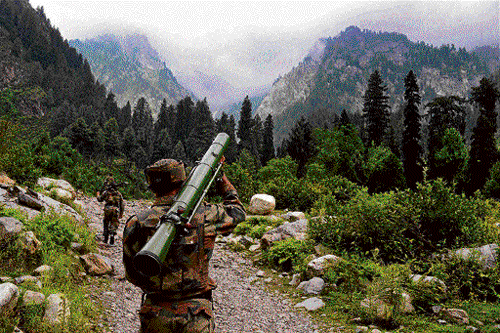 in hot pursuit: An Army personnel carries a rocket launcher during a combing operation at Uri sector in Baramulla  district on Wednesday. PTI