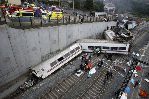 Rescue workers pull victims from a train crash near Santiago de Compostela, northwestern Spain, July 24, 2013. At least 35 people died after a train derailed in the outskirts of the northern Spanish city of Santiago de Compostela, the head of Spain's Galicia region, Alberto Nunez Feijoo, told Cadena Ser radio on Wednesday. A woman who was close to the site of the accident told the radio station that she had first heard a loud explosion and then seen the train derailed. REUTERS