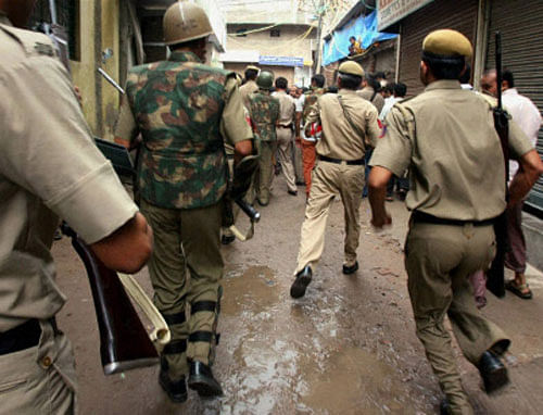 Policemen rush to Batla House during the encounter in New Delhi in Sep 2008. A Delhi court on Thursday ruled that the encounter was genuine and convicted lone suspected Indian Mujahideen operative Shahzad Ahmed of killing Delhi police inspector MC Sharma. PTI File Photo