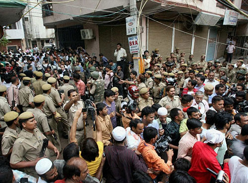 Police and residents during the Batla House encounter in New Delhi in Sep 2008. A Delhi court on Thursday ruled that the encounter was genuine and convicted lone suspected Indian Mujahideen operative Shahzad Ahmed of killing Delhi police inspector MC Sharma. PTI Photo