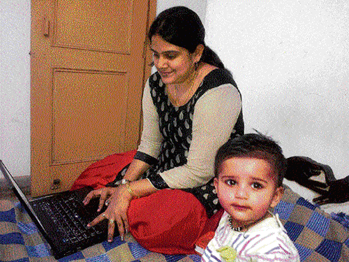 Working mommy at home: Medha Gupta did not have to give up working to raise her baby, thanks to her company's flexi-work policy.