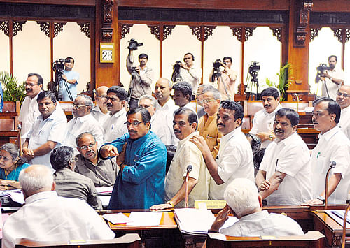 BJP members stage a  dharna at the well of the Legislative Council on Friday. dh photo