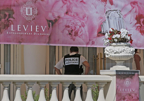 A policeman is seen at the Carlton hotel, in Cannes, southern France, the scene of a daylight raid, Sunday, July 28, 2013. A staggering 40 million euro ($53 million) worth of jewels and diamonds were stolen Sunday from the Carlton Intercontinental Hotel in Cannes, in one of Europe's biggest jewelry heists recent years, police said. French Riviera hotel was hosting a temporary jewelry exhibit over the summer of the prestigious Leviev diamond house, which is owned by Israeli billionaire Lev Leviev. (AP Photo)