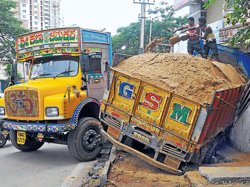 sorry sight: The sand lorry which rammed the compound wall of a building in the City on Monday. DH photo