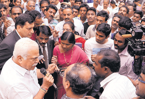 Patient hearing: Higher Education Minister R V Deshpande speaks to students and parents at the KEA premises in Bangalore on Monday. DH Photo