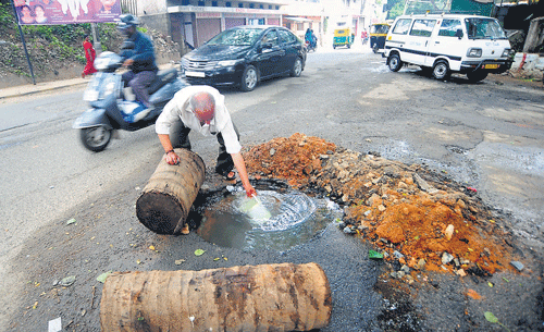 This is no natural spring that has made a sudden appearance, but BWSSB&#8200;apathy at its best. A resident scoops up water from a broken drinking water supply pipe on the road dug up for repair work in Vasanth Nagar.