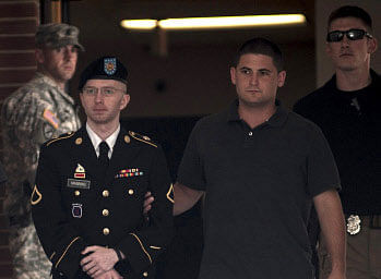 Bradley Manning is escorted out after closing arguments in his military trial at Fort Meade, Maryland