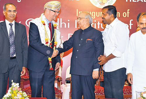 Warm greetings: Governor H R Bhardwaj greets Dr Rudiger Krech, the director of the Department of Ethics and Social  Determinants of Health, WHO (Geneva) during the inauguration of the Rajiv Gandhi Institute of Public Health and Centre for Disease Control in the City on Tuesday. RGUHS Vice Chancellor Dr K S Sriprakash, Health and Family Welfare Minister U T  Khader and Medical Education Minister Dr Sharanprakash Patil are seen. dh photo