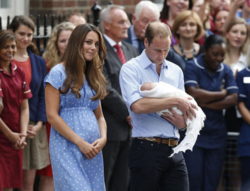 This July 23, 2013 file photo shows Britain's Prince William, right, and Kate, Duchess of Cambridge with the Prince of Cambridge as they pose for photographers outside St. Mary's Hospital in London. Princess Diana wore a caftan-like outfit that hid the post-childbirth tummy bump when William was born. In contrast, the former Kate Middleton, in her first public appearance on July 23, 2013, after giving birth, wore a dress that did not camouflage her belly, and many women are applauding her choice. AP Photo