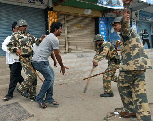 Security officers use batons to charge at a man protesting after India's ruling coalition endorsed creating a new state in southern India, Wednesday, July 31, 2013, in Ananthapur in Andhra Pradesh state, India. The United Progressive Alliance coalition unanimously agreed on Tuesday to endorse that a new state called Telangana be carved out of Andhra Pradesh state. Telangana would become India's 29th state. (AP Photo)