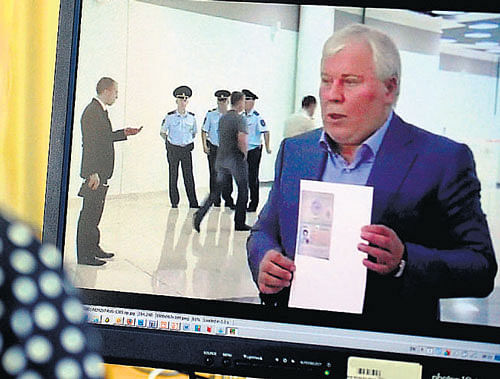 Anatoly Kucherena, the lawyer of fugitive US intelligence leaker Edward Snowden, shows his client's one year's asylum permit at Sheremetyevo airport in Moscow on Thursday. AFP
