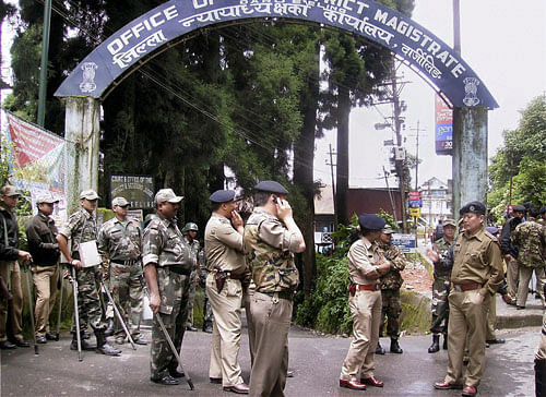 Policemen outside the District Magistrate's office during the 72-hour bandh called by Gorkha Janmukti Morcha demanding a separate Gorkhaland in Darjeeling on Tuesday. PTI Photo