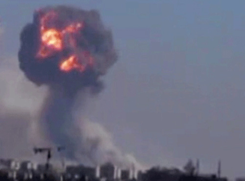 In this image taken from video posted by Shaam News Network, which has been authenticated based on its contents and other AP reporting, purports to show a fireball from an explosion at a weapons depot set off by rocket attacks that struck government-held districts in the central Syrian city of Homs on Thursday, Aug. 1, 2013. The blasts sent a massive ball of fire into the sky, killing scores and causing widespread damage and panic among residents, many of whom are supporters of President Bashar Assad.(AP Photo)