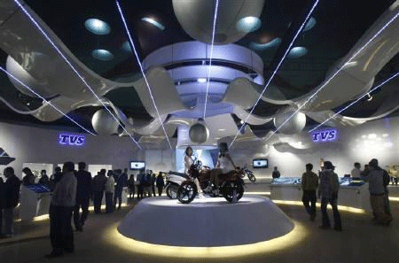 Visitors walk at TVS motorcycle pavilion at India's Auto Expo in New Delhi January 6, 2010. Reuters
