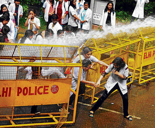 Medical students brave water cannons during a protest at Jantar Mantar in New Delhi on Thursday against the government's decision to make one year rural posting mandatory for doctors. PTI