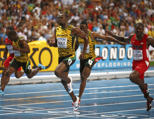 Usain Bolt of Jamaica (C) crosses the finish line to win the men's 100 metres final next to Justin Gatlin (R) of the U.S. during the IAAF World Athletics Championships at the Luzhniki stadium in Moscow August 11, 2013. REUTERS