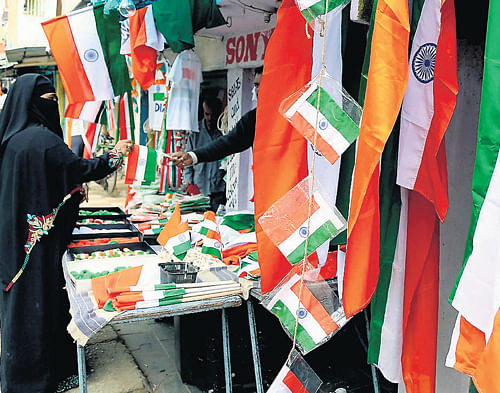 Vendors of the National Flags do a brisk business on the eve of Independence Day in  Bangalore on Wednesday. KPN