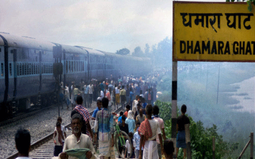 Angry people set ablaze Raj Rani Express train after it ran over pilgrims at Dhamara Ghat railway station, in Khagaria on Monday. PTI Photo