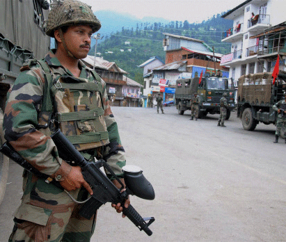 Army personnel stand guard a market street on the third consecutive day of curfew imposed after violence broke out in Kishtwar, in Bhahderwah, Doda on Tuesday. PTI Photo