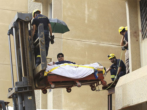 Saudi Civil Defence members use a forklift to move Khaled Mohsen Shaeri, 20, from his house in the Saudi city of Jizan, and to be airlifted to the capital Riyadh for medical treatment, August 19, 2013. Shaeri weighs approximately 610 kg (1345 lbs) and is suffering from severe obesity due to health problems that have resulted in a rapid increase in his weight over the past two years. REUTERS