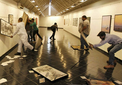 PTI File Image: Activist of Vishwa Hindu Parishad (VHP) damage paintings and photographs of Pakistani artists at an exhibition inside Hussain Doshi Art Gallery during a protest against Pakistan, in Ahmedabad.