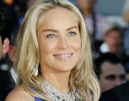 Actress Sharon Stone poses on the red carpet as she arrives for the screening of the film 'Behind the Candelabra' in competition during the 66th Cannes Film Festival in Cannes May 21, 2013. REUTERS