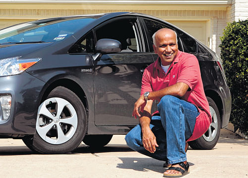 Pandian Athirajan poses next to his Toyota Prius Hybrid that he bought in May, in Austin, Texas. NYT