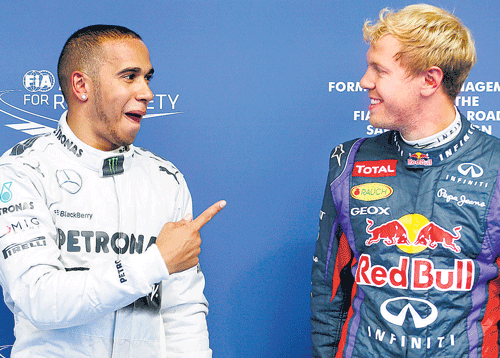 got you mate!: Mercedes' Lewis Hamilton (left) gestures after beating Sebastian Vettel for the Belgian GP pole. reuters
