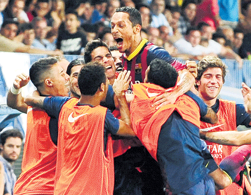 the saviour: Adriano is mobbed by his Barcelona team-mates after scoring against Malaga during their Spanish League enconuter on Sunday. AP