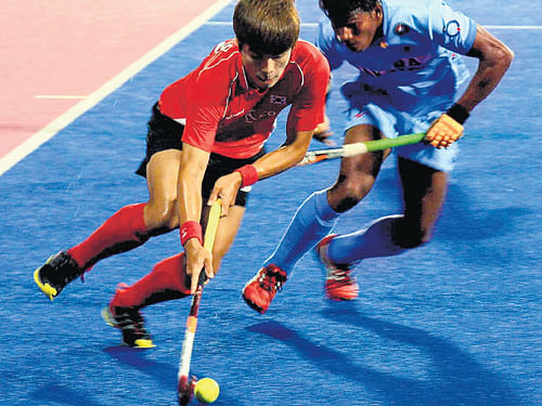 keen tussle: A goalmouth action during India's match against Korea in Ipoh on Monday.