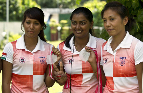 Women archers Rimil Buriuly (L), Deepika Kumari (C) and Bombayla Devi pose with their gold medals during a meeting with the V. K. Malhotra President of Archery Association of India in New Delhi on August 27, 2013. The Indian team defeated the top seeded Koreans to win the gold medal at the 2013 archery World Cup in Wroclaw, Poland. AFP PHOTO