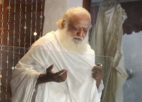 Self-styled godman Asaram Bapu interacts with media at his ashram in Indore on Tuesday. PTI Photo