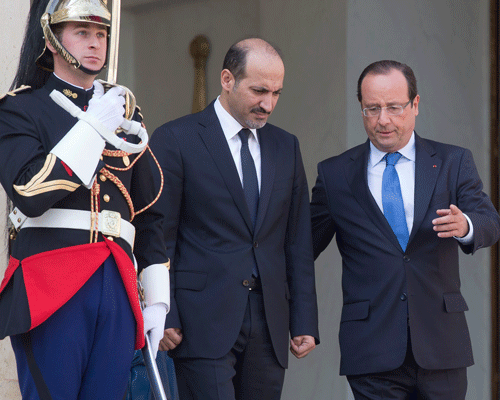 Head of the Syrian National Coalition, Ahmad al-Jarba, left, and France's President Francois Hollande, right, walk towards the media at the end of their meeting at the Elysee Palace Thursday Aug. 29, 2013. AP Photo