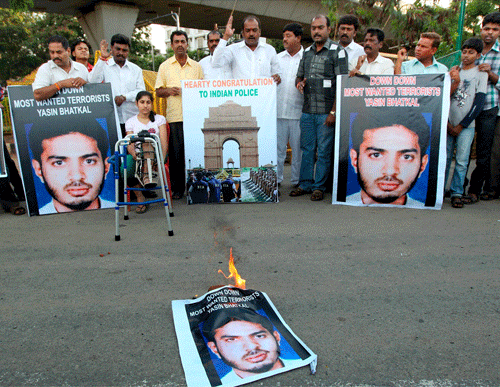 Members of Youth Congress burn a poster of wanted terrorist Yasin Bhatkal during a protest in Bengaluru on Thursday. PTI Photo