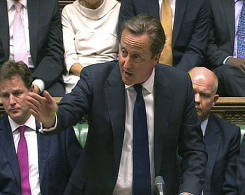 In this image taken from video, Britain's Prime Minister David Cameron, centre, speaks during a debate on Syria, in Britain's parliament, London, Thursday August 29, 2013. Britain's leaders said Thursday it would be legal under humanitarian doctrine to launch a military strike against Syria even without authorization from the United Nations Security Council, but it is not certain how much support there is for the government's resolution on Syria. Behind Cameron are British Foreign Secretary William Hague, obscured 2nd right, and Deputy Prime Minister Nick Clegg, left. (AP Photo