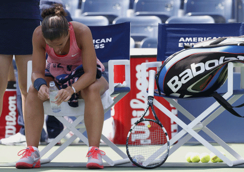 Sara Errani of Italy sits during a break in play against compatriot Flavia Pennetta at the U.S. Open tennis championships in New York August 29, 2013. REUTERS