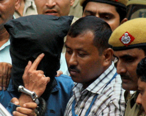 National Investigating Agency personnel escort Indian Mujahideen mastermind Yasin Bhatkal who was being produced at the Patiala House courts in New Delhi on Friday. PTI Photo by Manvender Vashist