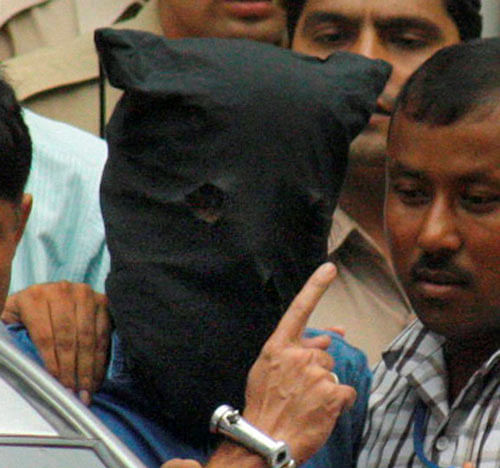 National Investigating Agency personnel escort Indian Mujahideen mastermind Yasin Bhatkal who was being produced at the Patiala House courts in New Delhi on Friday. PTI Photo