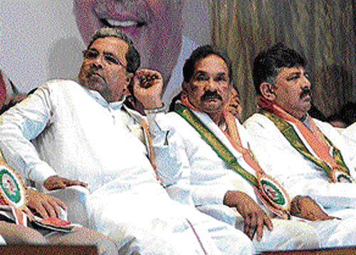 In deep thought: Minister of State for Labour Parameshwar Naik, Chief Minister Siddaramaiah, Home Minister K J George and MLA D K Shivkumar at the State-level convention of the unorganised workers in Bangalore on Sunday. DH Photo