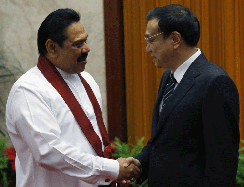 Sri Lanka's President Mahinda Rajapaksa (L) shakes hands with China's Premier Li Keqiang at the Great Hall of the People in Beijing, May 29, 2013. REUTERS