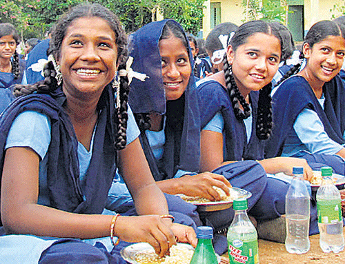 Less than rosy: Students enjoy their midday meals at the Kadugodi government school. The school, which is a part of the survey, has a high incidence of student dropouts. DH photo