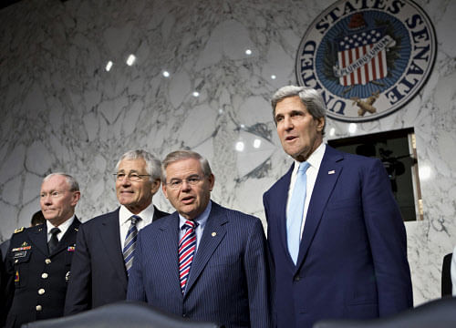 Senate Foreign Relations Chairman Robert Menendez, D-N.J., second from right, stands with, from left, Joint Chiefs Chairman Gen. Martin Dempsey, Defense Secretary Chuck Hagel, and Secretary of State John Kerry, on Capitol Hill in Washington, Tuesday, Sept. 3, 2013, prior to the start of the committee's hearing on President Barack Obama's request for congressional authorization for military intervention in Syria. (AP Photo)