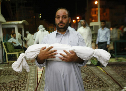 Nabil Ahmed carries the dead body of his 2-year old son, Mohammed, who was killed in a car bomb, during the funeral in the Shiite holy city of Najaf, 100 miles (160 kilometers) south of Baghdad, Iraq, Wednesday, Sept. 4, 2013. The killings come amid a spike in deadly violence in recent months as insurgents try to capitalize on rising sectarian and ethnic tensions. The scale of the bloodshed has risen to levels not seen since 2008, a time when Iraq was pulling back from the brink of civil war. (AP Photo)
