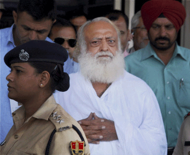 Asaram Bapu, after being arrested from his Indore ashram by Jodhpur police, arrives at Jodhpur airport on Sunday. PTI Photo