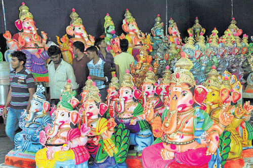 Festive preparations: Idols of Ganesha in different shapes and forms arrayed for sale at a make-shift shop in Mysore on Friday. dh photo