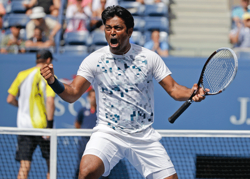 Leander Paes, of India, turns and reacts to his partner Radek Stepanek, of the Czech Republic, during the men's doubles quarterfinals against Mike and Bob Bryan at the 2013 U.S. Open tennis tournament, Thursday, Sept. 5, 2013, in New York. (AP Photo