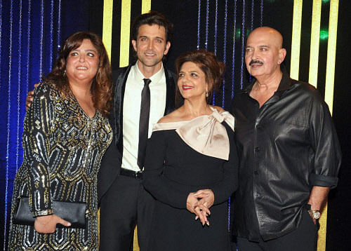 Actor Hrithik Roshan with sister Sunaina (L), mother Pinky during birthday party of his father Rakesh Roshan (R) in Mumbai on Friday. PTI Photo